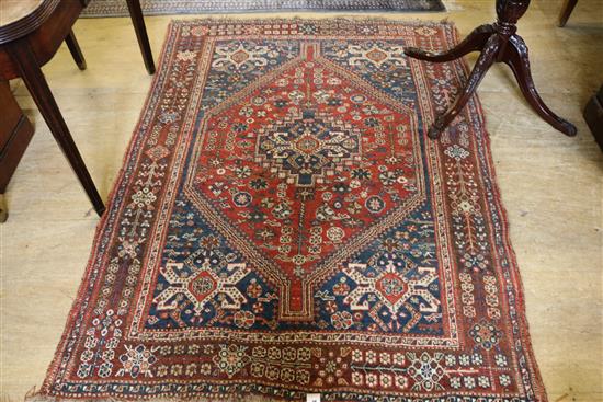 A Caucasian red ground rug, 5ft 10in by 4ft 4in.